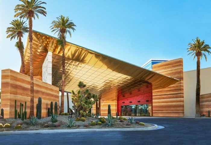 Virgin Hotels Las Vegas, a gay-friendly Curio Collection by Hilton. Exterior view of the hotel entrance with desert landscaping.