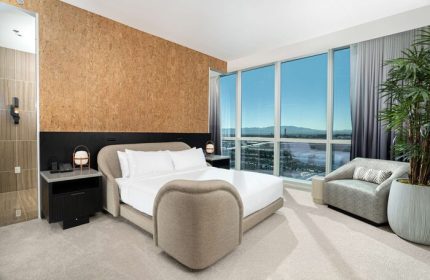 Virgin Hotels Las Vegas Curio Collection by Hilton guest room. Gay-friendly hotel with modern design, city view, and comfortable seating.