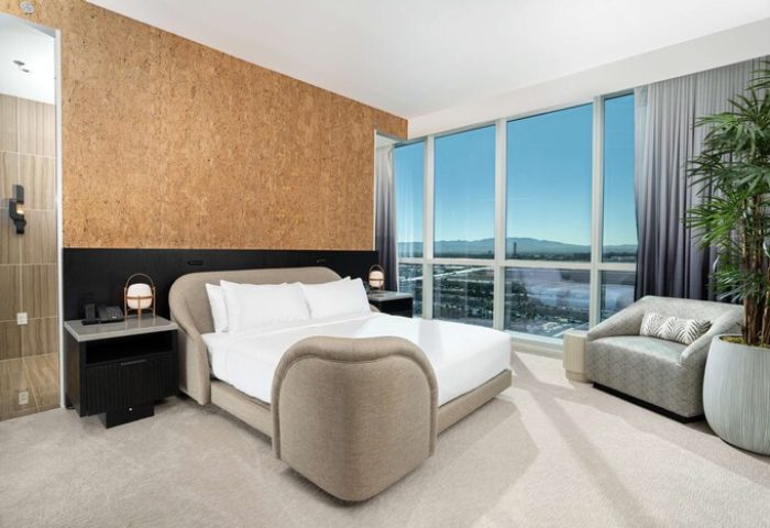 Virgin Hotels Las Vegas Curio Collection by Hilton guest room. Gay-friendly hotel with modern design, city view, and comfortable seating.