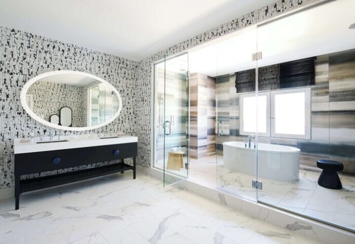 Virgin Hotels Las Vegas bathroom. Curio Collection by Hilton gay-friendly hotel features a modern design with a soaking tub and glass shower.