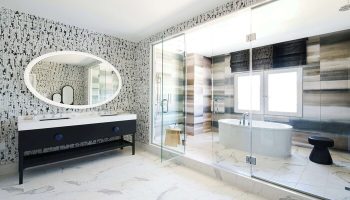 Virgin Hotels Las Vegas bathroom. Curio Collection by Hilton gay-friendly hotel features a modern design with a soaking tub and glass shower.