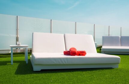 Vista Bonita Gay Resort: White lounge chairs with red towels on green turf. Relax at this gay-friendly hotel, a top gay travel destination.