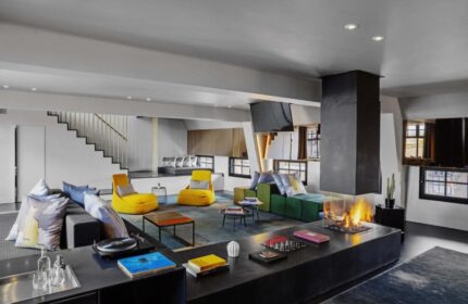 W Amsterdam hotel's stylish lounge. Gay-friendly hotel with modern design, colorful seating, fireplace, and a relaxed atmosphere. Ideal for gay travelers.