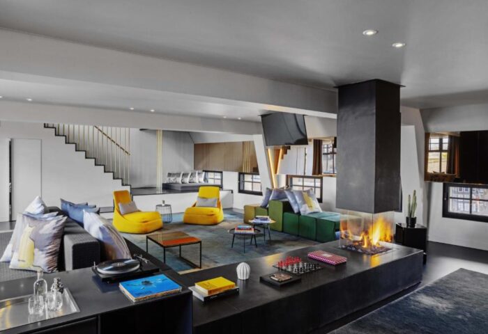 W Amsterdam hotel's stylish lounge. Gay-friendly hotel with modern design, colorful seating, fireplace, and a relaxed atmosphere. Ideal for gay travelers.