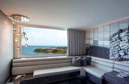W Chicago Lakeshore hotel room interior. Gay-friendly hotel with lake view, stylish decor, and comfortable seating. Great for gay travel.