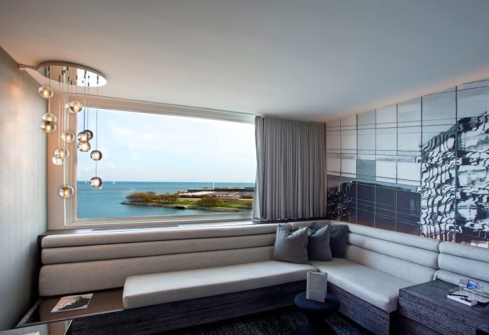 W Chicago Lakeshore hotel room interior. Gay-friendly hotel with lake view, stylish decor, and comfortable seating. Great for gay travel.