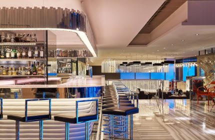 W Chicago Lakeshore gay-friendly hotel bar. Chic interior, stylish bar stools, and a well-stocked liquor shelf. Modern design.