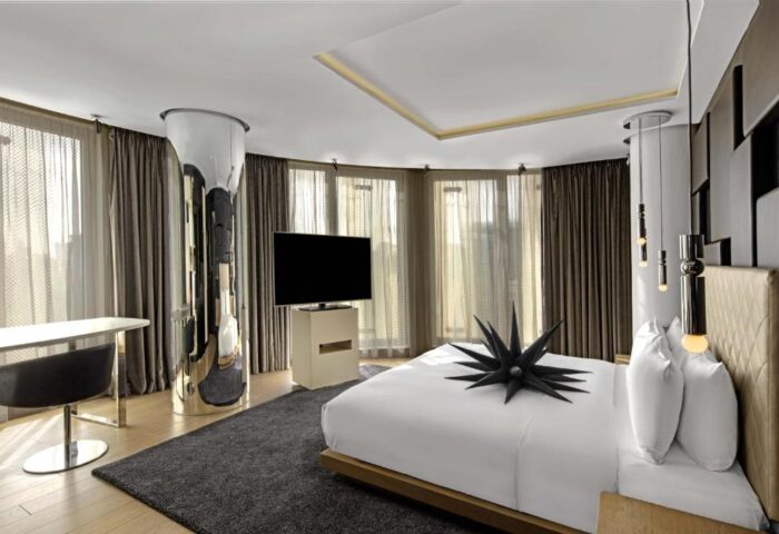 W London Leicester Square hotel room. Pet-friendly, gay-friendly hotel with modern decor, large windows, and a king-size bed.