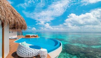 W Maldives gay-friendly hotel: Overwater bungalow with private pool overlooking the turquoise ocean. Perfect for gay couples' travel.