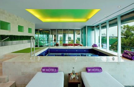 W Mexico City gay-friendly hotel spa. Lounge chairs and a pool with views. Perfect for gay travelers seeking luxury in Mexico City.