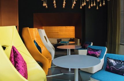 W Mexico City gay-friendly hotel interior. Colorful chairs, tables, and lighting create a modern, inviting space. Perfect for LGBT travelers.