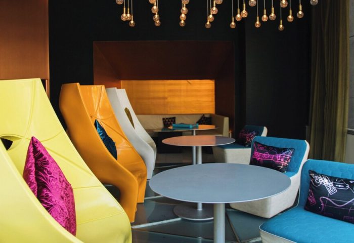 W Mexico City gay-friendly hotel interior. Colorful chairs, tables, and lighting create a modern, inviting space. Perfect for LGBT travelers.