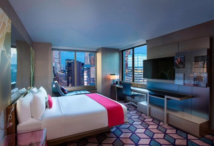 W New York Times Square hotel room at night. Gay-friendly hotel with city view. Modern interior design. Travel advice for gay men.