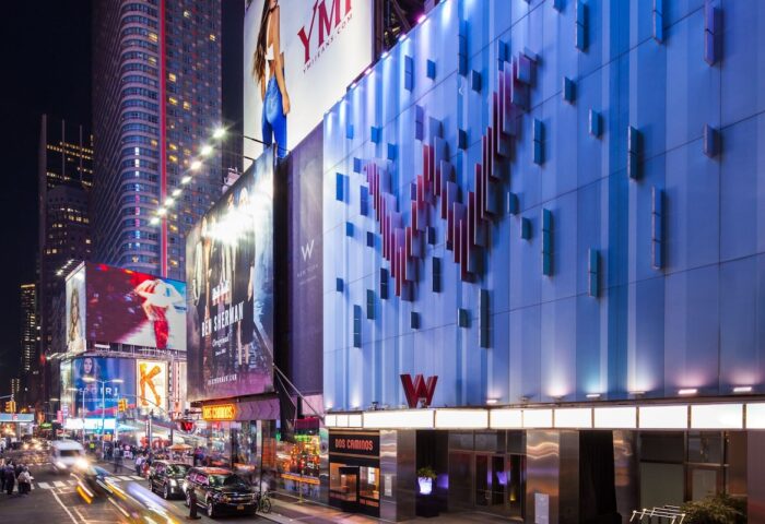 W New York - Times Square Hotel facade at night. Gay-friendly hotel in NYC with modern design and vibrant city views.