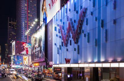 W New York - Times Square Hotel facade at night. Gay-friendly hotel in NYC with modern design and vibrant city views.