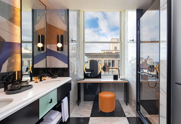 W New York - Union Square hotel bathroom. Modern design with black and white tile, vanity, and shower. Gay-friendly hotel travel.