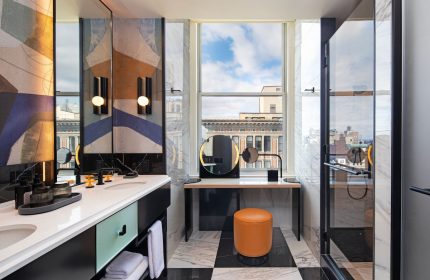 W New York - Union Square hotel bathroom. Modern design with black and white tile, vanity, and shower. Gay-friendly hotel travel.