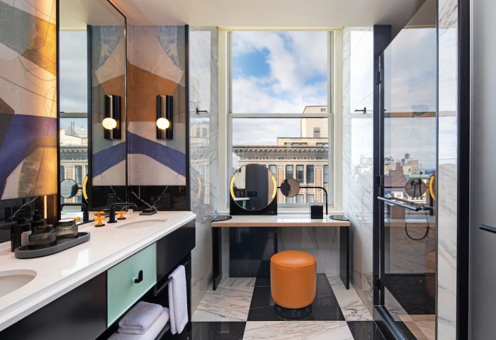 W New York - Union Square hotel bathroom. Modern design with black and white tile, vanity, and shower. Gay-friendly hotel travel.