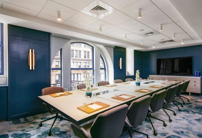 W New York - Union Square gay-friendly hotel meeting room. Long table with chairs, large windows, and modern decor. Business travel.