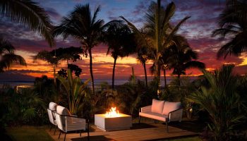 W Punta de Mita gay-friendly hotel outdoor seating area with fire pit at sunset. Palm trees and ocean view. Ideal for gay travel.