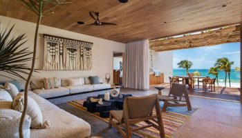 W Punta de Mita gay-friendly hotel suite. Open-air living room with ocean view, stylish decor, and comfortable seating. Perfect for gay travel.