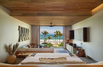 W Punta de Mita gay-friendly hotel room. Ocean view from bed, palm trees, beach. Luxury travel for gay men. Stylish decor, relaxing vibe.