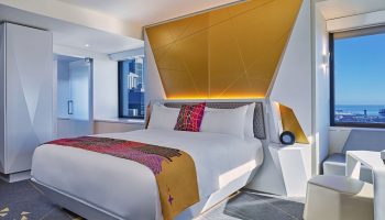 W San Francisco gay-friendly hotel room. Modern design with gold accents, geometric headboard, and city view. Ideal for gay travelers.