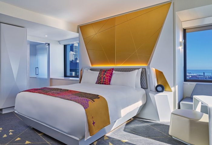 W San Francisco gay-friendly hotel room. Modern design with gold accents, geometric headboard, and city view. Ideal for gay travelers.