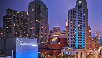 W San Francisco hotel at night. Gay-friendly hotel with city views. Blue Shield of California Theater in the foreground. Urban scene.