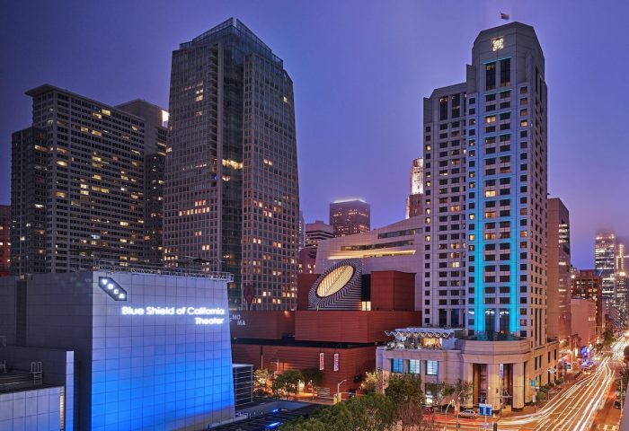 W San Francisco hotel at night. Gay-friendly hotel with city views. Blue Shield of California Theater in the foreground. Urban scene.