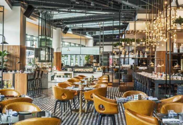 Interior of W Shanghai - The Bund, a gay-friendly hotel. Restaurant with leather chairs, tables, and bar. Modern design and decor. Upscale dining.