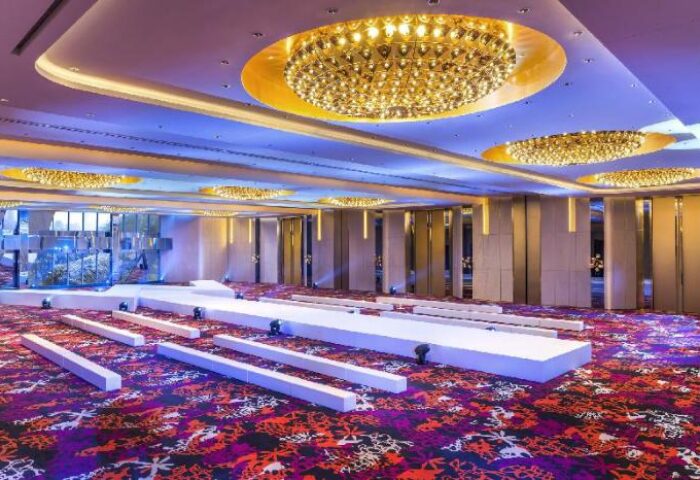 W Shanghai - The Bund gay-friendly hotel ballroom with stage. Ornate chandeliers, colorful carpet. Ideal for events. Shanghai travel.