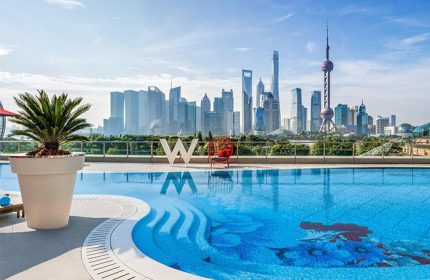 Pool at gay-friendly W Shanghai - The Bund hotel. Shanghai skyline view. Modern design, luxury travel. Great for gay men's vacation.