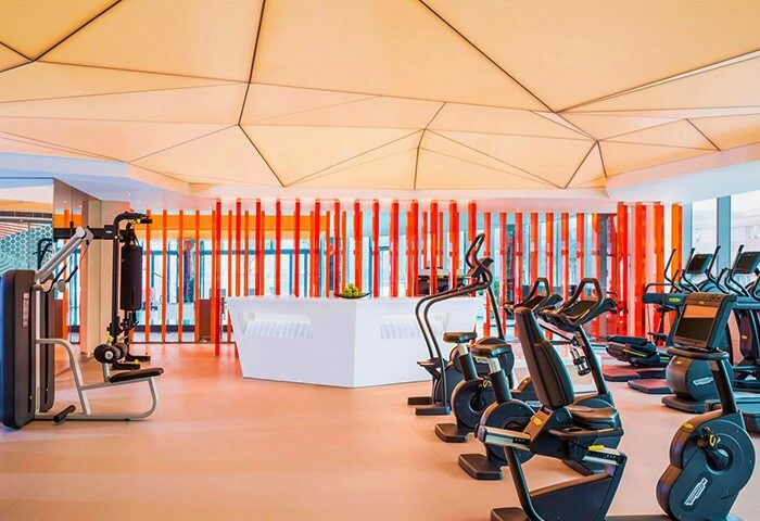 W Shanghai The Bund gym. Gay-friendly hotel fitness center with modern equipment. Exercise bikes & weight machines for a healthy stay.