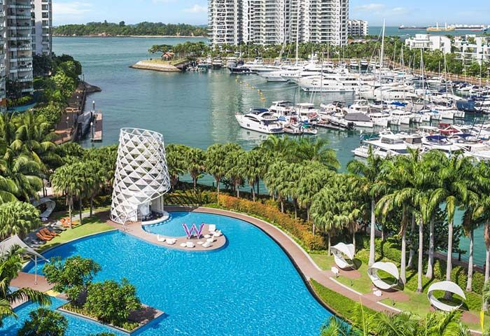 W Singapore - Sentosa Cove: Gay-friendly hotel view of pool, marina, and ocean. Luxury travel at SG Clean Certified resort.