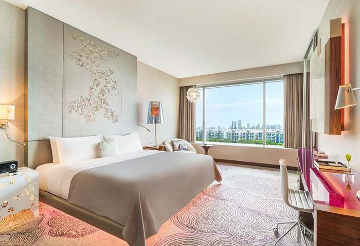 W Singapore Sentosa Cove gay-friendly hotel room. Modern design, large window with city view, comfortable bed, and stylish decor. SG Clean Certified.
