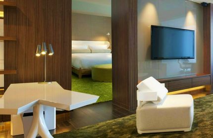 W Taipei hotel room interior. Modern design with a bed, TV, and stylish furniture. Gay-friendly hotel for gay men travelers.