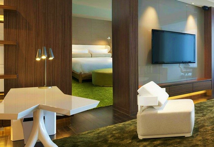 W Taipei hotel room interior. Modern design with a bed, TV, and stylish furniture. Gay-friendly hotel for gay men travelers.