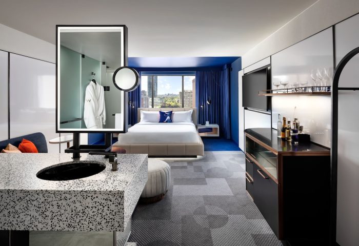 W Toronto hotel room. Modern design, blue accents, king bed, city view. Gay-friendly hotel with stylish interiors for a comfortable stay.