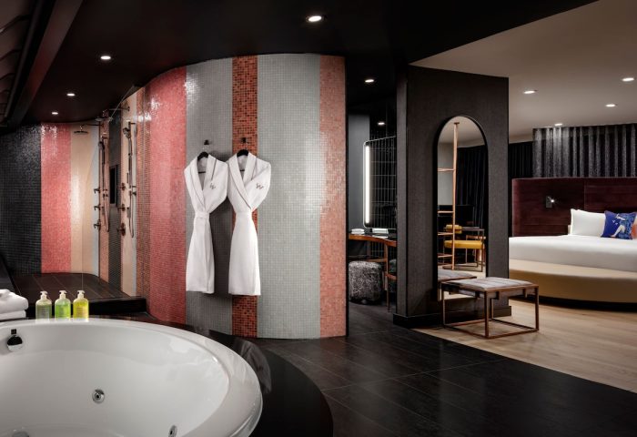 W Toronto hotel suite. Bathtub, mosaic tile shower, robes, and bedroom view. Gay-friendly travel at W Toronto for gay men.
