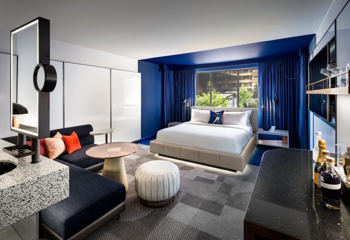 W Toronto hotel room interior. Modern design, blue accents, king bed, seating area. Gay-friendly hotel for gay travelers.