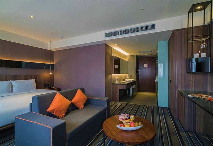 WESTGATE Hotel room interior. Modern design with a bed, sofa, and bathroom. Gay-friendly hotel for comfortable travel.