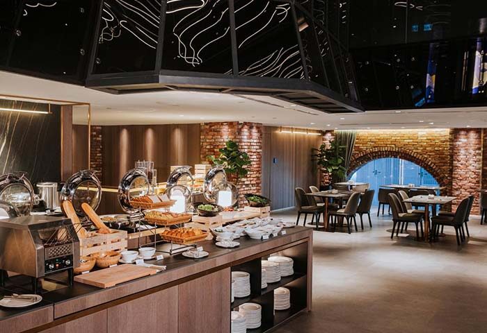 WOLO Kuala Lumpur gay-friendly hotel breakfast buffet. A modern buffet setup with brick archway at this Kuala Lumpur hotel.