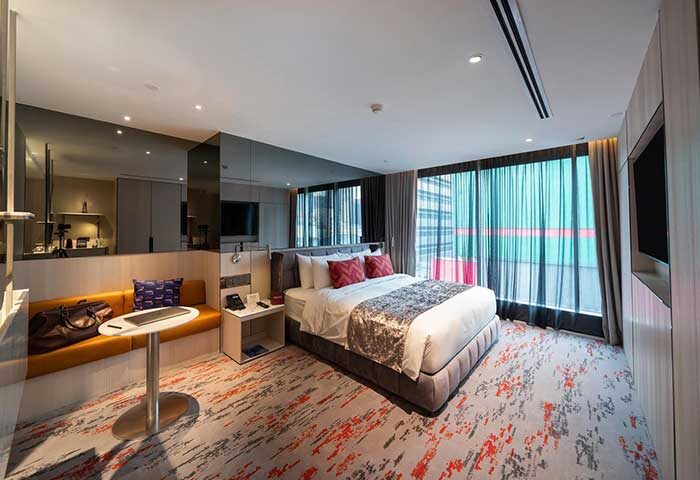 WOLO Kuala Lumpur gay-friendly hotel room. Modern design with bed, seating area, and city view. Ideal for gay travelers seeking style and comfort.