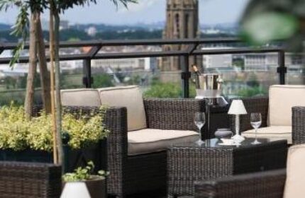 Wasserturm Hotel Cologne, a gay-friendly Curio Collection by Hilton. Outdoor seating area with city views. Perfect for gay travel.