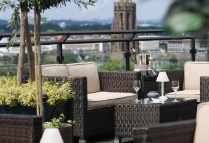 Wasserturm Hotel Cologne, a gay-friendly Curio Collection by Hilton. Outdoor seating area with city views. Perfect for gay travel.