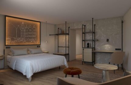 Wasserturm Hotel Cologne, a gay-friendly Curio Collection by Hilton. Modern room interior with bed, desk, & industrial design elements.
