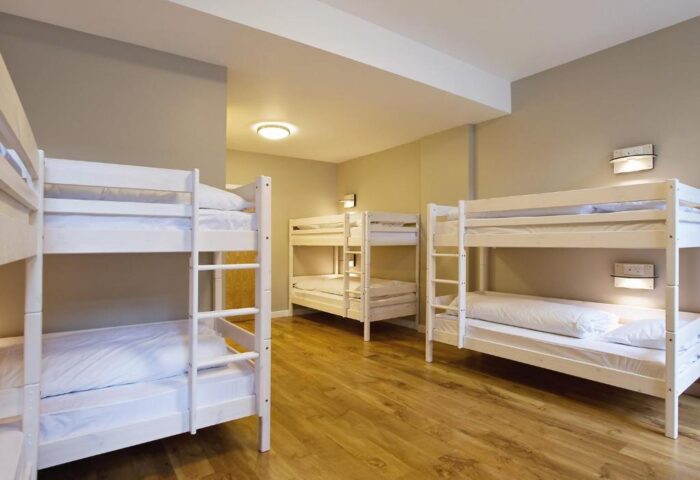 Wombats City Hostel London: Dorm room with white bunk beds, wood floor. Gay-friendly hotel for gay men travelers. Budget accommodation.