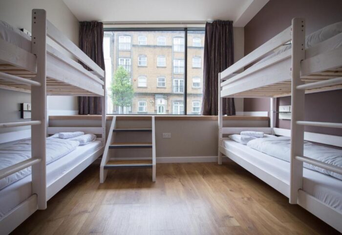 Wombats City Hostel London: Gay-friendly hotel room with two bunk beds, wooden floor, and a window view. Great for gay travelers on a budget.