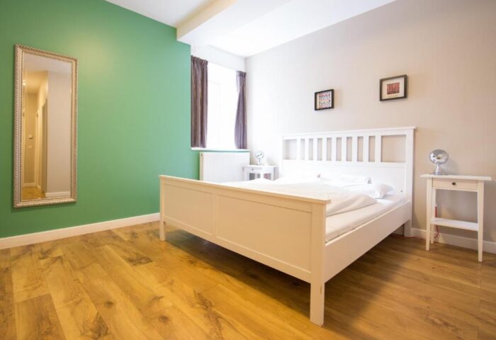 Wombats City Hostel London gay-friendly hotel room. Double bed, bedside tables and mirror. Great for gay travelers in London.